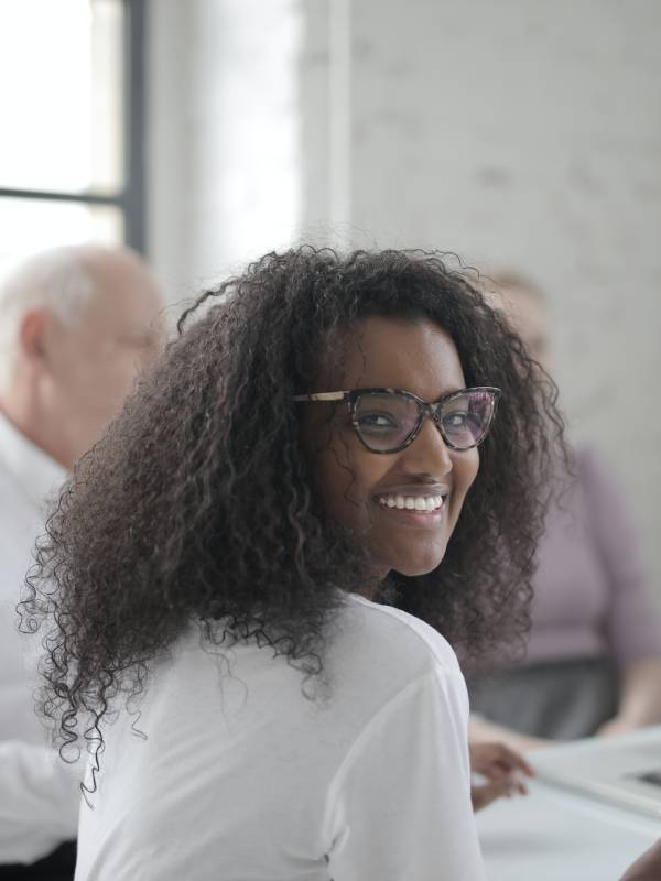 smiling-woman-working-in-office-with-coworkers